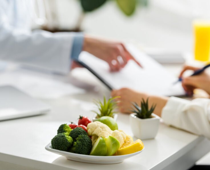 selective focus of tasty organic fruits and vegetables near women